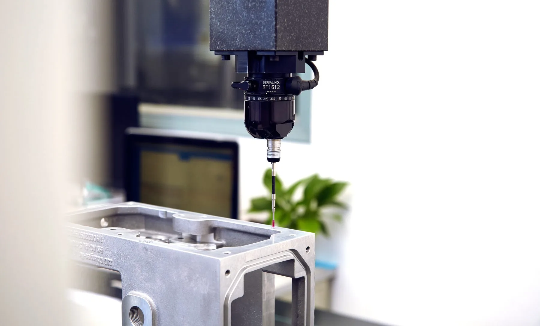 In-house metrology lab — a Renishaw CMM probe inspecting a precision aluminum casting